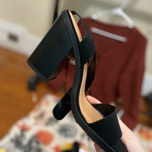 Black high heels with an ankle buckle